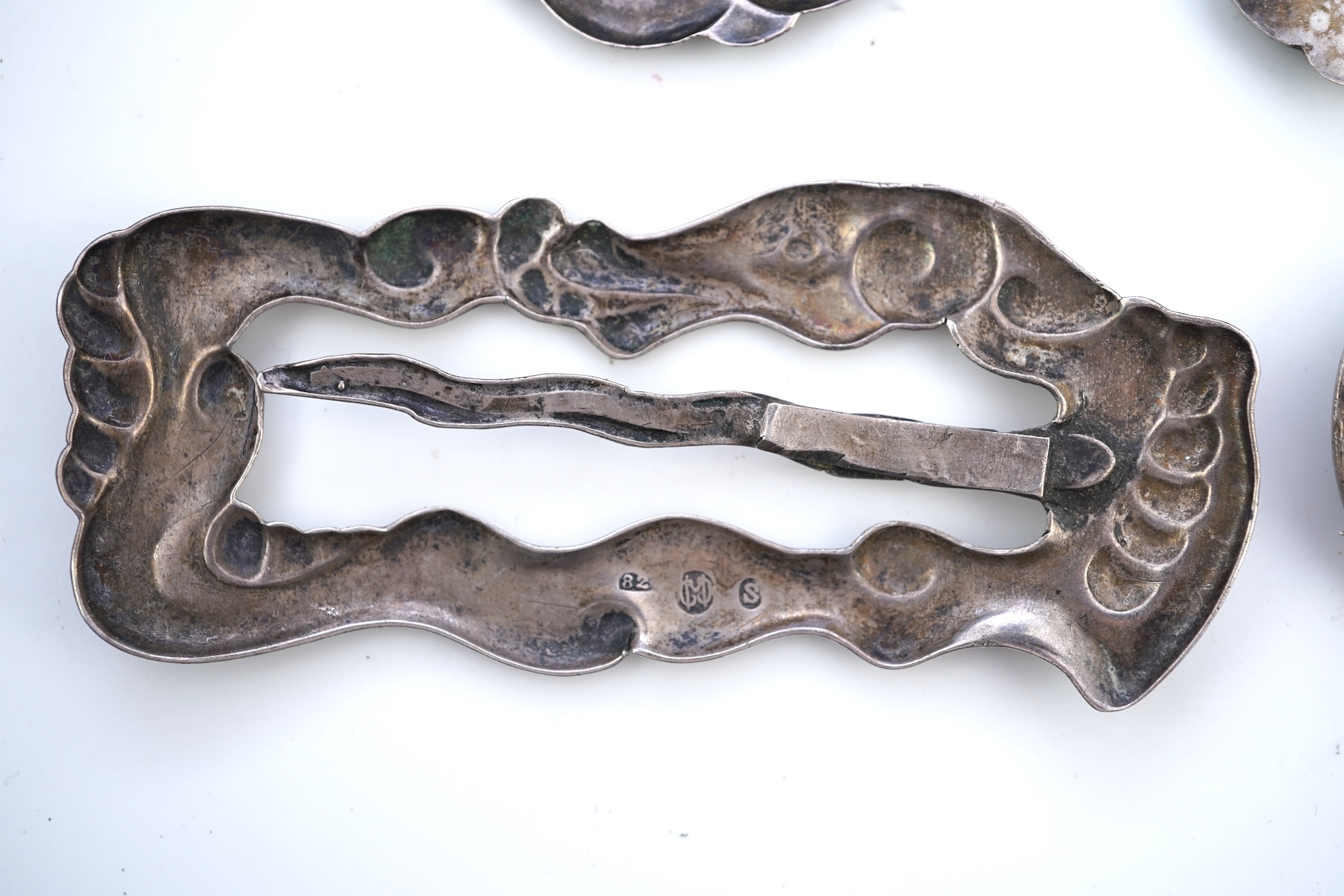 An Arts & Crafts silver slide and three silver brooches, probably Denmark, first half 20th century